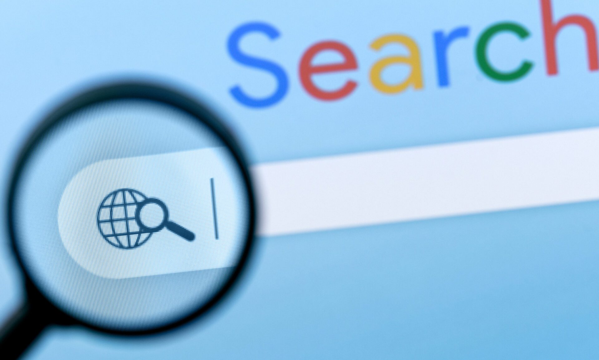 Browser search bar with globe and magnifying glass icon under magnifier lens