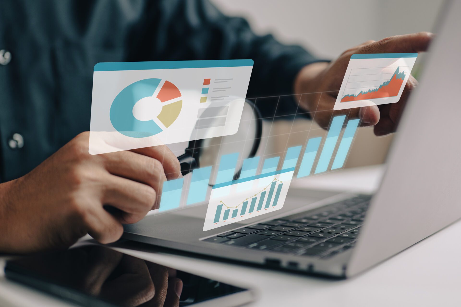 person using laptop with floating colorful charts and graphs in foreground