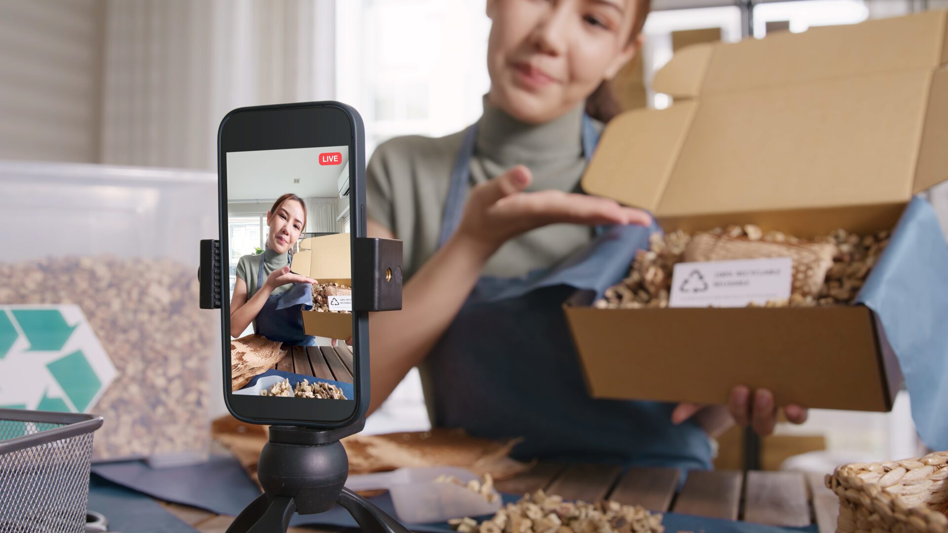 Young woman livestreaming sustainable retail packaging with eco-friendly materials